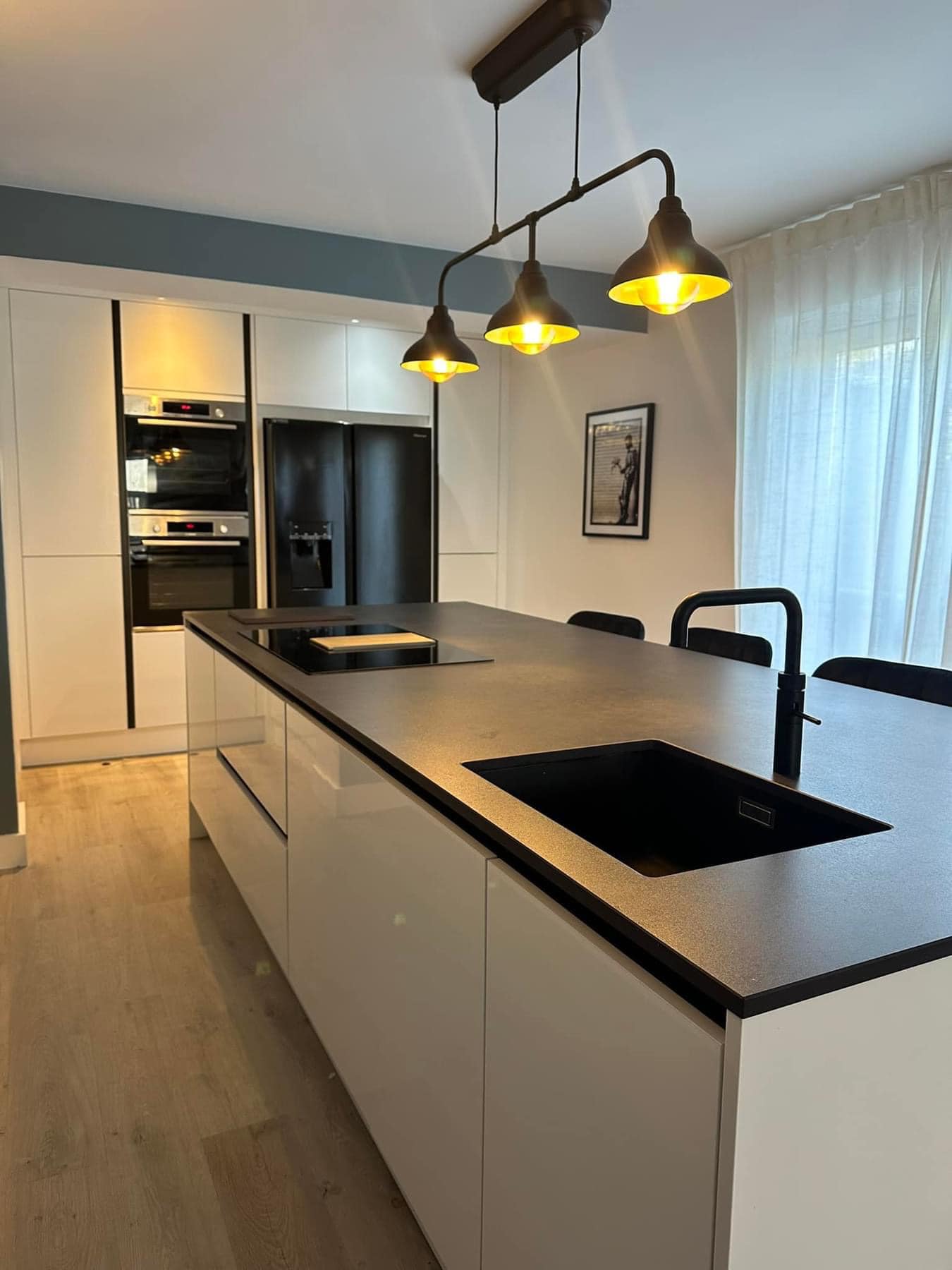 dark colour lights yellow warm glow onto kitchen